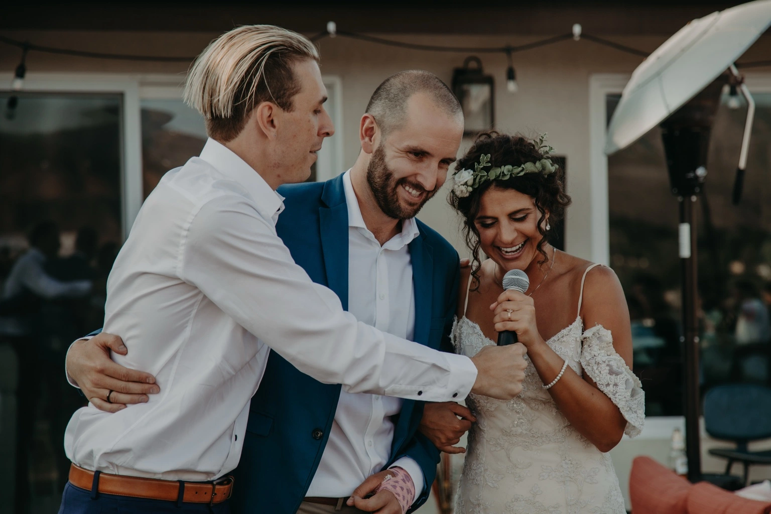 TREVAN sharing a joyful microphone moment with a wedding couple